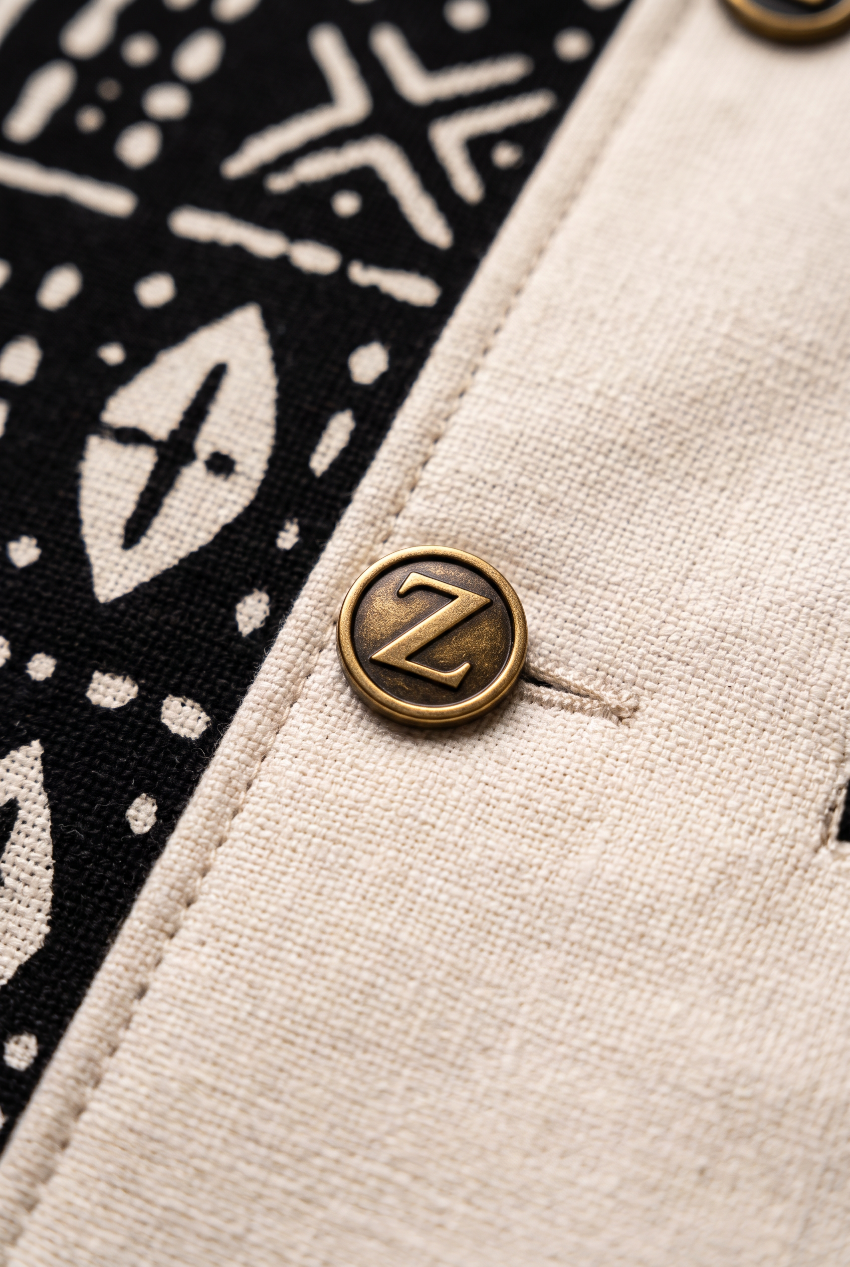 Bogolan Prestige Suit · Ivory Heritage — Men, 07 Fabric detail (view 7 of 7). Fabric detail: close study of the cloth, hand-printed mudcloth motif and stitching.