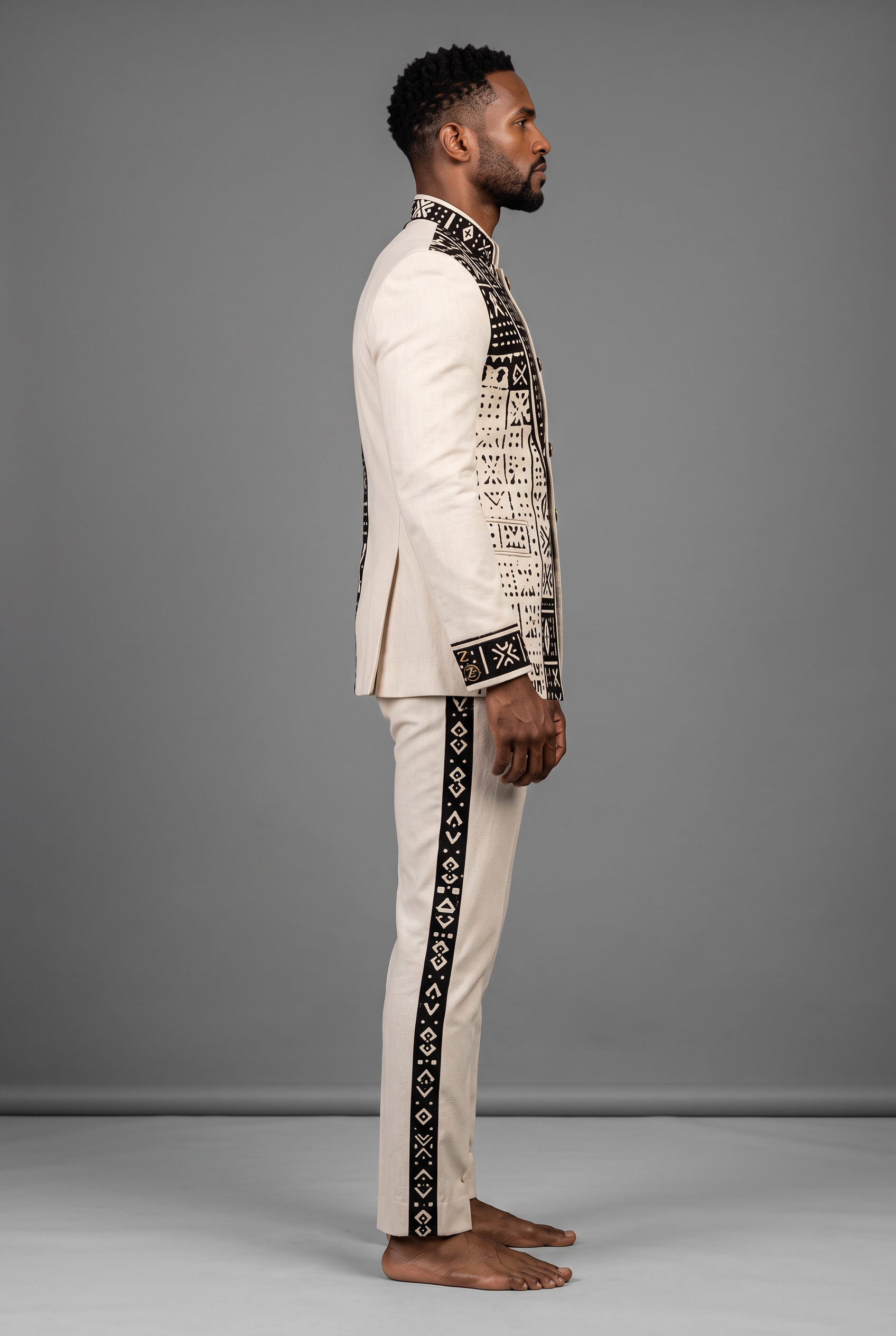 Bogolan Prestige Suit · Ivory Heritage — Men, 02 Left (view 2 of 7). Left profile: shoulder line, sleeve fall and the outer seam trim.