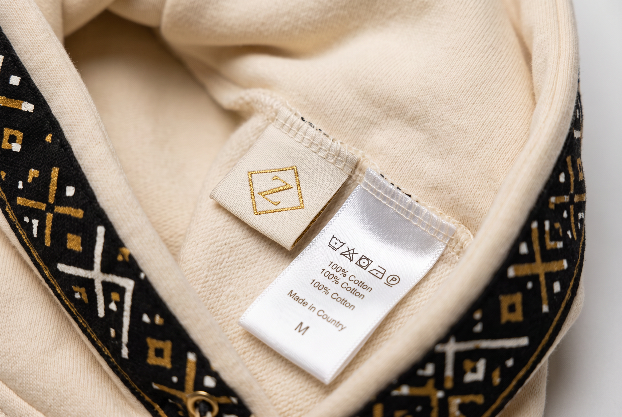 Bogolan Hoodie Set · Pearl Ivory — Women, 06 Inner tags (view 6 of 7). Inner tags: size scale, atelier reference and care instructions.