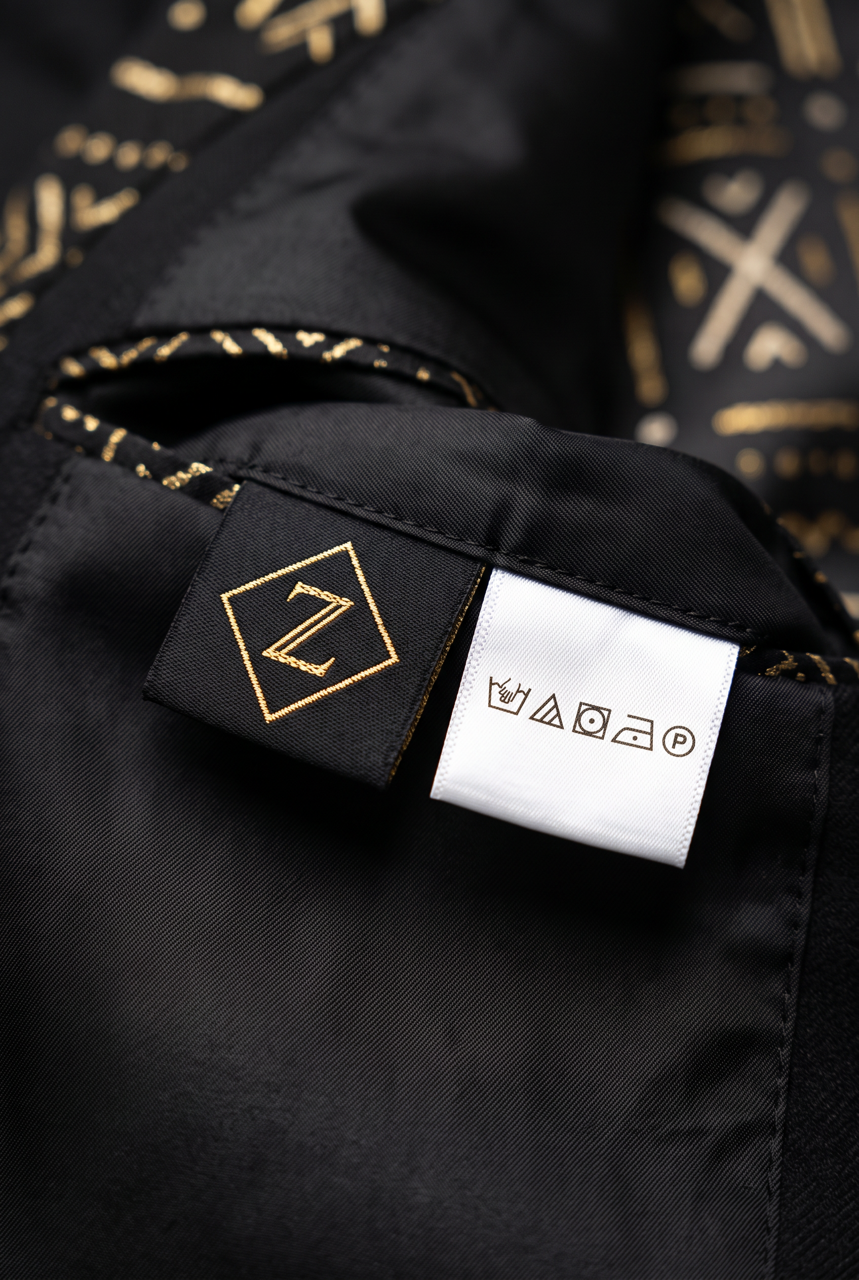 Heritage Thread Suit · Mud Black — Men, 06 Inner tags (view 6 of 7). Inner tags: size scale, atelier reference and care instructions.