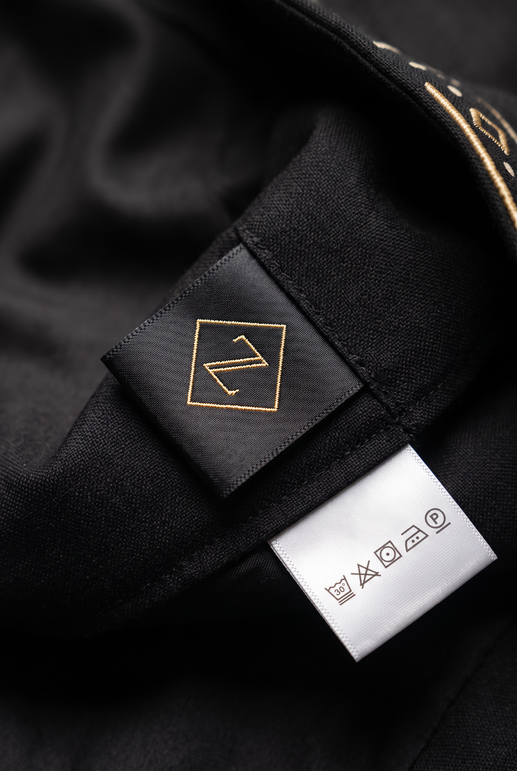 Redefined Heritage Suit · Onyx Black — Men, 06 Inner tags (view 6 of 7). Inner tags: size scale, atelier reference and care instructions.