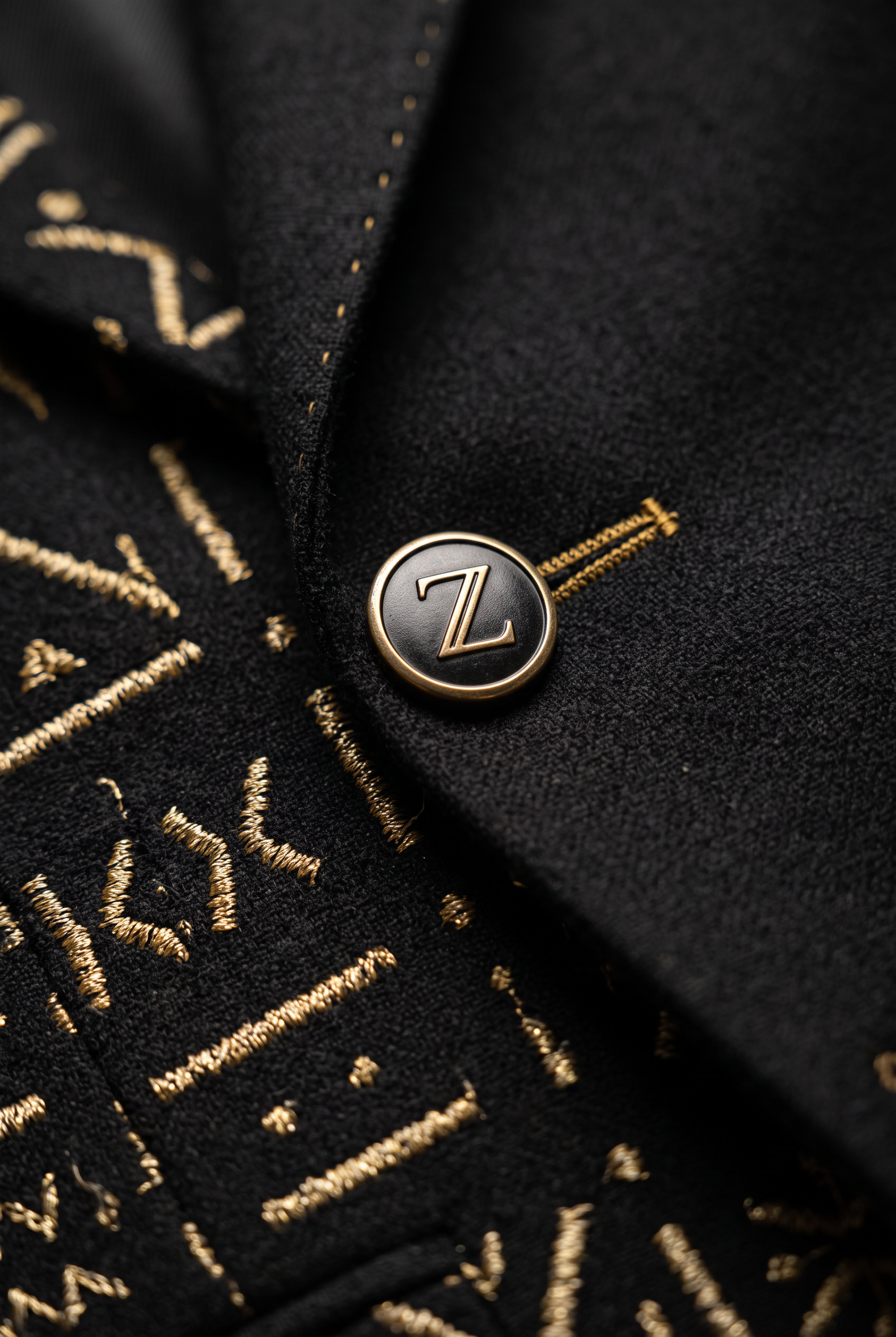 Heritage Thread Suit · Mud Black — Men, 07 Fabric detail (view 7 of 7). Fabric detail: close study of the cloth, hand-printed mudcloth motif and stitching.