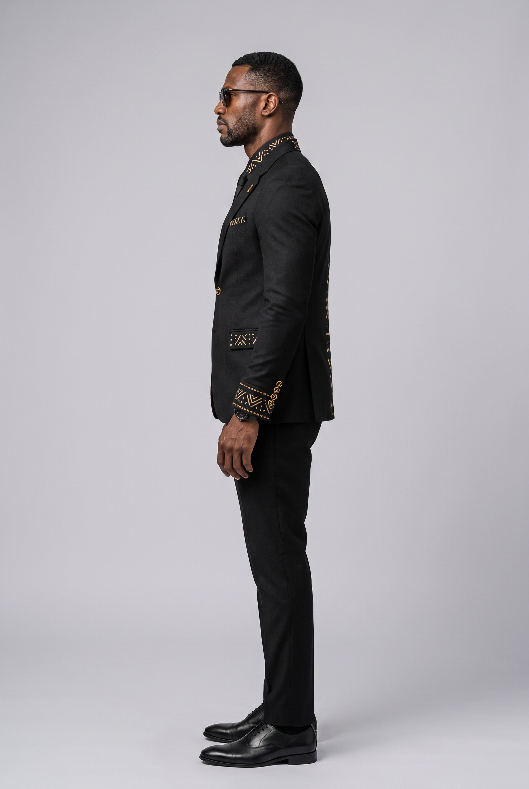 Heritage Thread Suit · Mud Black — Men, 02 Left (view 2 of 7). Left profile: shoulder line, sleeve fall and the outer seam trim.