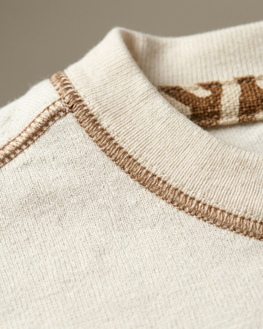 Ivory Legacy Tee — Men, 07 Fabric detail (view 7 of 7). Fabric detail: close study of the cloth, hand-printed mudcloth motif and stitching.