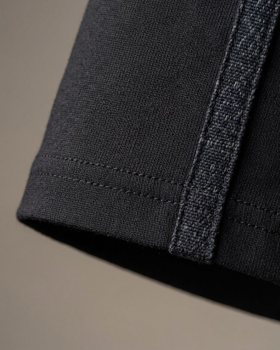 Onyx Heritage Tee — Men, 07 Fabric detail (view 7 of 7). Fabric detail: close study of the cloth, hand-printed mudcloth motif and stitching.