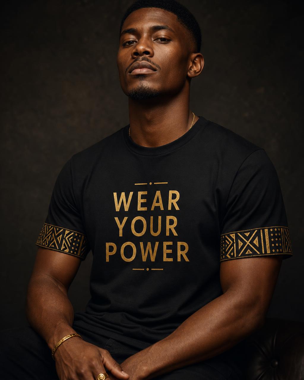 Model wearing the black round-neck short-sleeve Wear Your Power tee with gold Bogolan mudcloth sleeve bands