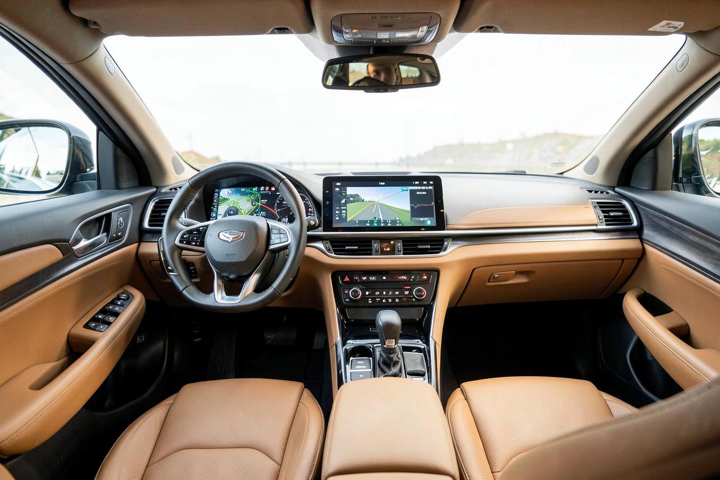 Vehicle cockpit with tan leather seats, dark trim and a wide dashboard touchscreen