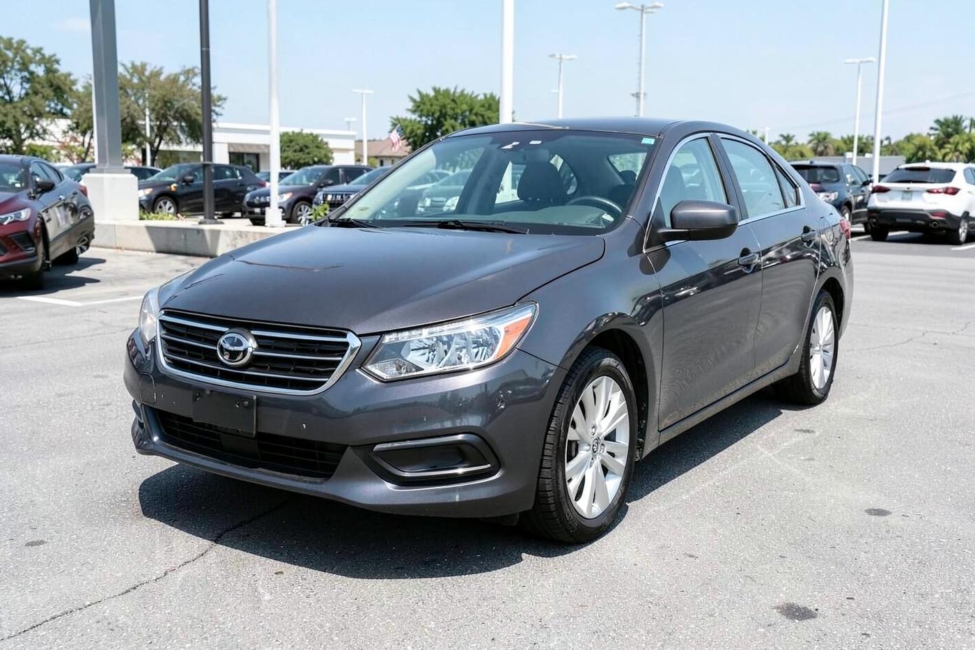 Graphite Corso Vela SE sedan parked on a certified pre-owned dealership lot